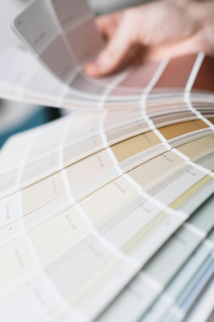 pexels-photo-6583367-6583367 Detailed close-up of a multi-colored color swatch palette being fanned out for interior design selection.